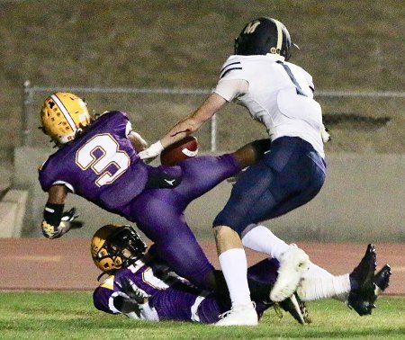 Lemoore's Cory Whitmore and Preston Scott struggle for a loose pass in the first half of Lemoore's playoff opener against Mission Prep.